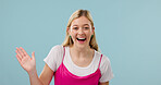 Laughing, portrait and woman in studio, waving and greeting with smile, space and positive attitude. Blue background, hello and happy person with gesture, welcome and excited for introduction in USA