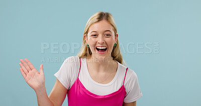 Buy stock photo Laughing, portrait and woman in studio, waving and greeting with smile, space and positive attitude. Blue background, hello and happy person with gesture, welcome and excited for introduction in USA