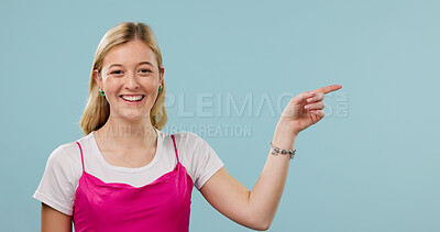 Buy stock photo Happy, pointing and fashion with portrait of woman in studio for announcement, retail news and space. Sale promotion, style advertising and mockup with female person on blue background for offer