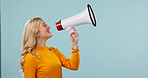 Megaphone, space and woman in studio with news, announcement and info for retail sale. Happy, mockup and person with loudspeaker for communication, broadcast and voice for deal on blue background