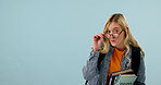 College student, education and woman with glasses in studio, science knowledge and mockup space. Learning, books and person with academic vision, biology scholarship or portrait on blue background