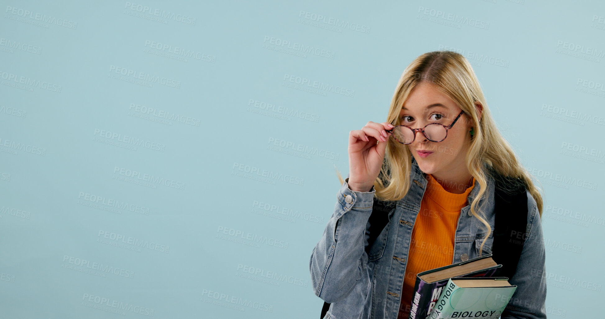 Buy stock photo College student, education and woman with glasses in studio, science knowledge and mockup space. Learning, books and person with academic vision, biology scholarship or portrait on blue background