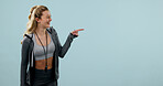 Woman, fitness and point in studio for advertising, gym info or news on exercise membership. Communication, about us and personal trainer with mockup, space or happy with announcement on background