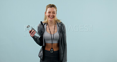 Buy stock photo Woman, happy and fitness with water in studio, portrait of gym instructor and stopwatch. Excited, smile and drink with female personal trainer, health and wellness with confidence on blue background