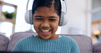 Buy stock photo Streaming, headphones or girl in home with show, cartoon series or online game on weekend break. Happy, multimedia or child on sofa with laptop, comedy entertainment or playing in digital competition