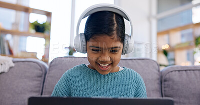 Buy stock photo Streaming, headphones or girl in home with laptop, cartoon series or online game on weekend break. Happy, multimedia or child on sofa with tech, comedy entertainment or playing in digital competition