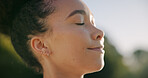 Mindfulness, breathing and woman with smile on break, outdoor and relax with inner peace on weekend. Calm, person and stress relief with fresh air at park, thinking and happy with thoughts on holiday