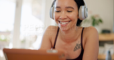 Buy stock photo Laugh, headphones and woman in home on tablet for internet, watching videos and podcast on weekend. Happy, relax and person on digital tech for website, streaming and listening to audio for break