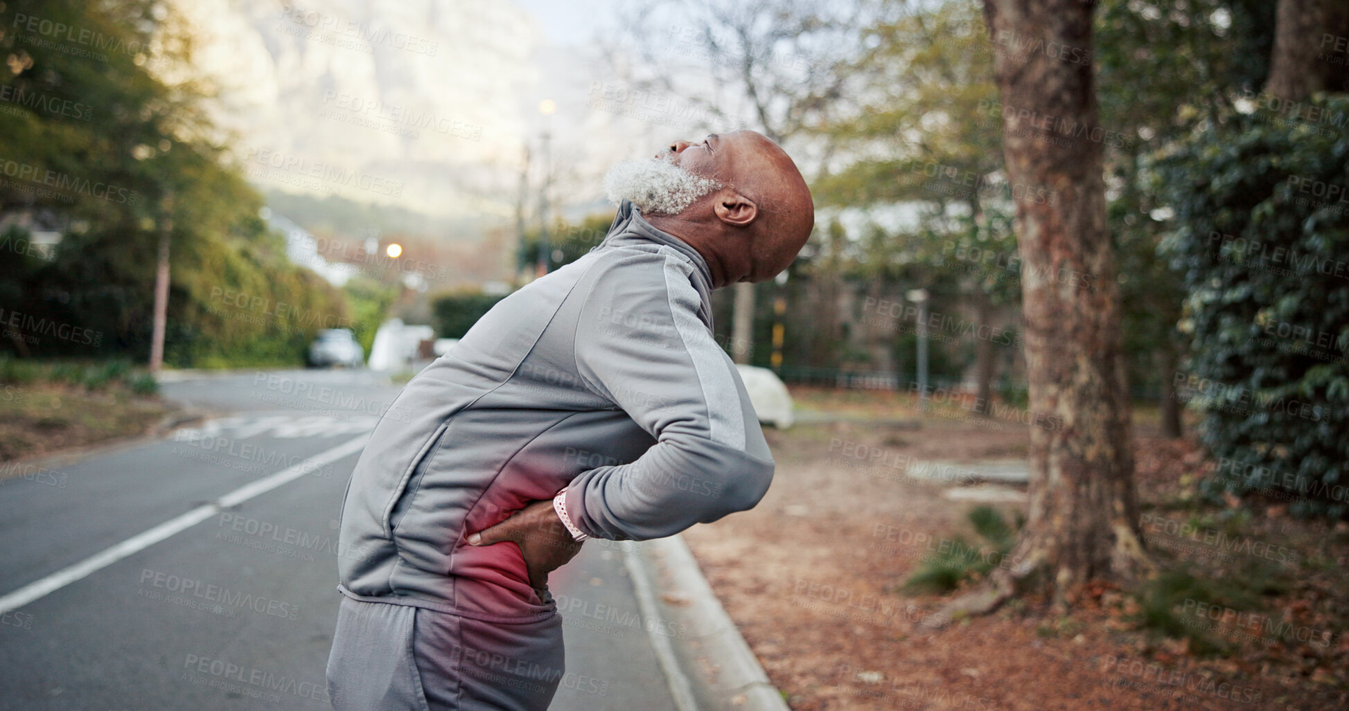Buy stock photo Black man, stretching and retirement with back pain for fitness, accident and sprain from exercise. Old person, discomfort and red glow outdoor with joint cramp, muscle injury and burnout from sports