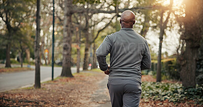 Buy stock photo Back, man and running in nature for fitness, exercise and cardio training for morning routine. Mature person, runner and sprinting at park for endurance, physical activity and workout for wellness