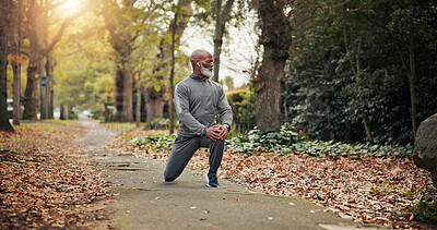 Buy stock photo Fitness, earphones or old man in park with stretch, leg mobility or audio playlist in retirement activity. Digital, knee or black person with tech, warm up music or muscle improvement in senior hobby