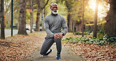 Buy stock photo Fitness, earphones or old man outdoor with stretch, leg mobility or audio playlist in wellness activity. Digital, knee or black person with tech, warm up music or muscle improvement in senior hobby.