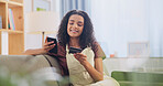 Credit card, phone and woman on sofa in house for online shopping, ecommerce or website purchase. Technology, happy and person with internet banking for payment on cellphone in living room at home.