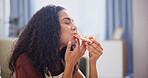 Eating, relax and woman with pizza in home for dinner, fast food or supper in living room on holiday. Bite, hungry and person in apartment with Italian takeaway, snack or meal on weekend break.