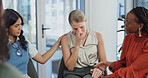 Group therapy, crying and support with woman, empathy or understanding with trauma in community center. Emotional, counseling and comfort sad person with kindness, help and holding hands for care