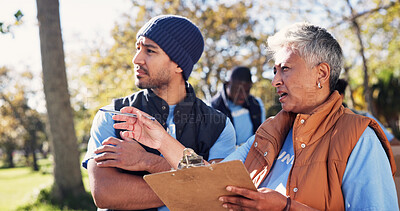 Buy stock photo Clipboard, pointing and talking with volunteer people in park together for charity or relief work. Conversation, instructions and checklist with community team outdoor for discussion or planning