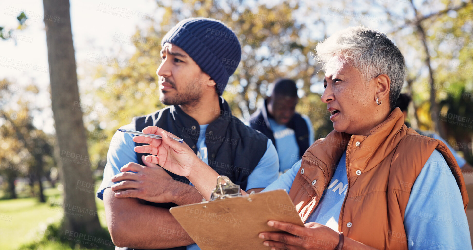 Buy stock photo Clipboard, pointing and talking with volunteer people in park together for charity or relief work. Conversation, instructions and checklist with community team outdoor for discussion or planning