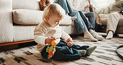 Buy stock photo Baby, home and playing with toys on floor in living room for development, fun or growth. Experience, learning and motor skills with boy child in apartment for cognitive curiosity or sensory activity