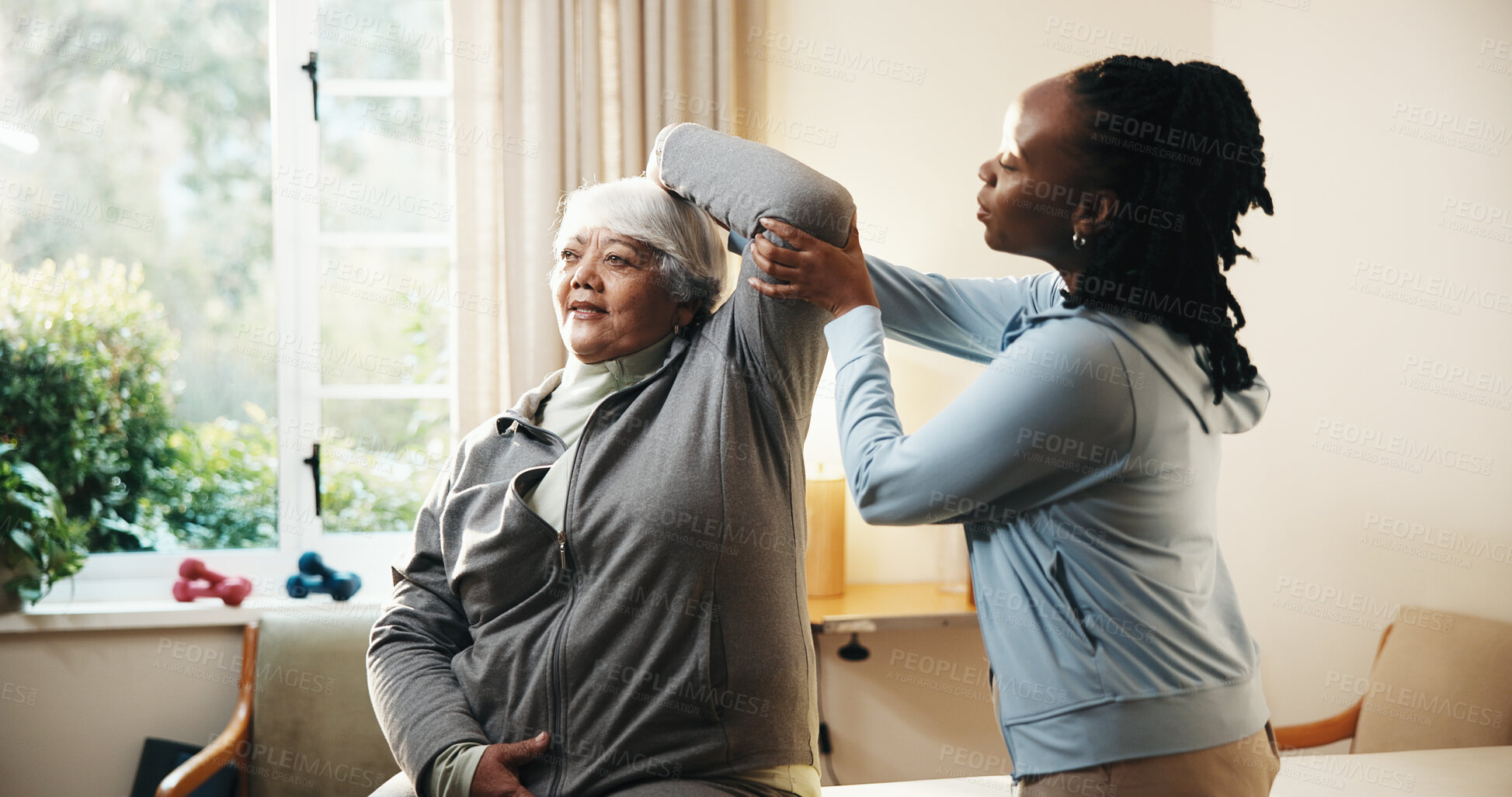 Buy stock photo Physiotherapist, stretching and old woman at house for physio, mobility or guidance for recovery. Chiropractor, senior person or physiotherapy in home with support, shoulder injury and rehabilitation