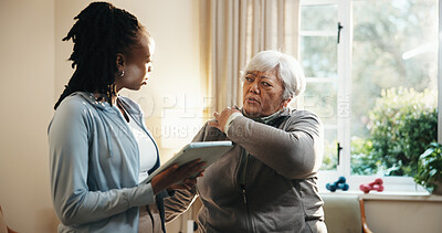 Buy stock photo Old woman, shoulder pain and physiotherapist with tablet in home for consulting or rehabilitation. App, feedback and senior patient with chiropractor in apartment for concern, recovery or review