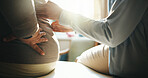 Hands, massage and old person with back pain for physio, assessment or stiffness for recovery. Physiotherapist, senior patient or physiotherapy in office for checkup, muscle injury and rehabilitation
