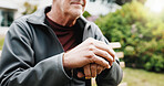Hands, cane and thinking in backyard with senior person in retirement, balance aid and reflection. Pensioner, memory or nostalgia for past perspective, walking stick and mobility outdoor at house