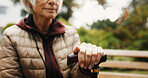 Hand, walking stick and thinking outdoor with senior person in retirement, balance aid and reflection space. Old woman, memory or nostalgia for past perspective, relax in nature or cane for mobility