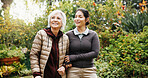 Help, caregiver and walk with old woman at park for support, smile and thinking of recovery. Retirement, care and person with carer in nature for rehabilitation assistance, happiness and wellness