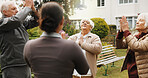Woman, physiotherapist or meditation with senior group in garden for mindfulness together. Female person, instructor or elderly people with breathing exercise for health or wellness in retirement