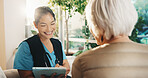 Consultation, tablet and old woman with caregiver for conversation, support or service in nursing home. Homecare, senior person and nurse with healthcare, feedback and checkup review in living room