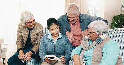Buy stock photo Retirement, caregiver and reading book with people in home for puzzle, crossword or memory game. Carer, senior group and cognitive activity in lounge, word search or brain teaser with happy friends