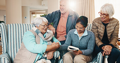 Buy stock photo Handshake, caregiver or reading book with old people in home for puzzle, crossword or memory game. Carer, retirement or shaking hands with happy friends, word search success, brain teaser and flare