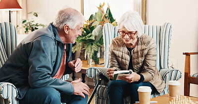 Buy stock photo Smile, old couple and reading at house with crossword, word search and quiz for health. Senior people, helping and book in home with sudoku games, problem solving and puzzle activity for brain teaser