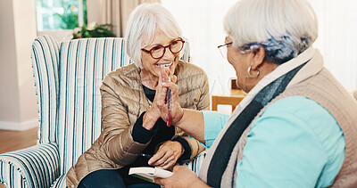 Buy stock photo Smile, old people and high five at house with book, word search and encourage for crossword. Happy, senior women and friends in lounge with sudoku, answer success and achievement for puzzle activity
