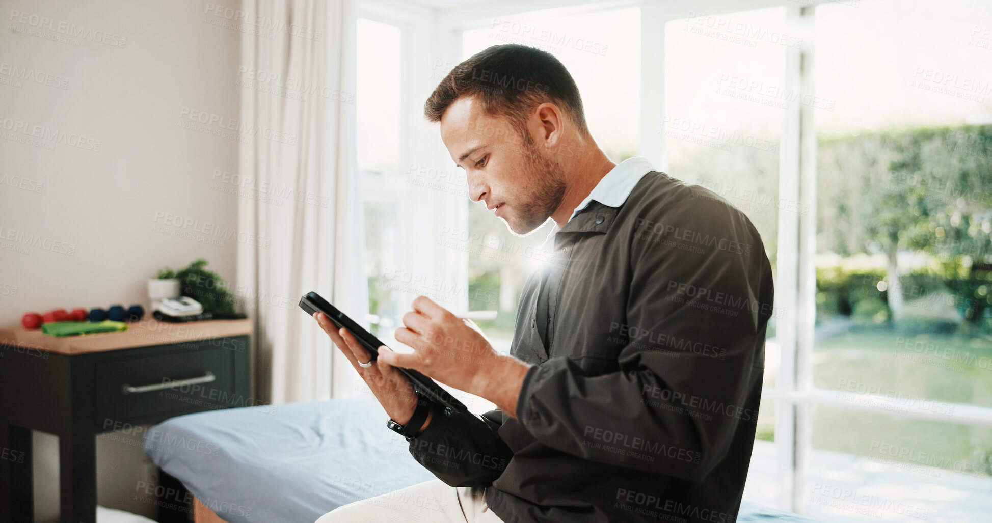 Buy stock photo Clinic, reading and man on tablet for physiotherapy, appointment schedule and medical report. Healthcare, online and person with tech, stylus and research for physical therapy, review and planning