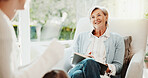 Smile, woman and therapist in office for counseling, assessment and advice for mental health. Happy, psychologist and notebook in workplace for therapy session, evaluation and rehabilitation progress