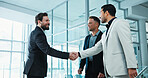 Businessman, team and handshake with introduction in office for business deal or agreement together. Male people, employees or colleagues shaking hands with smile for b2b or partnership in workplace