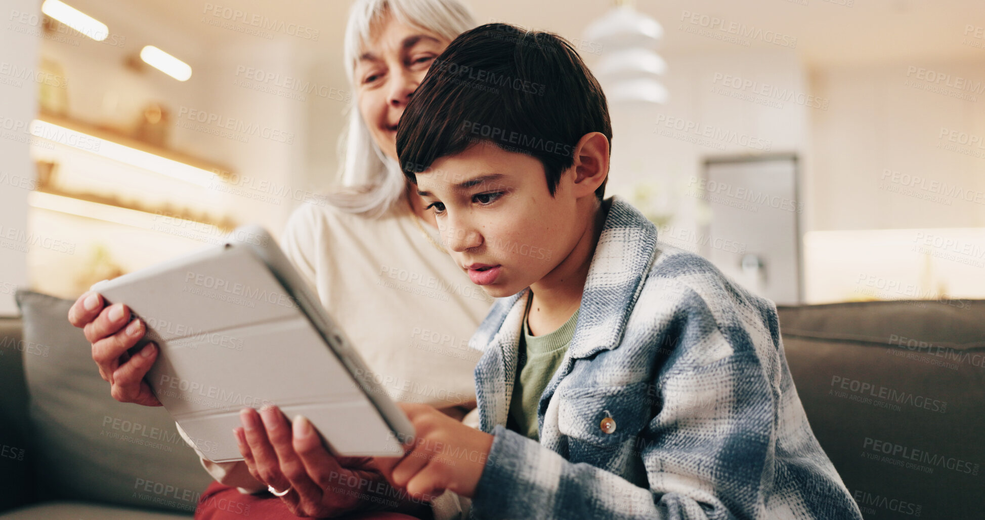 Buy stock photo Relax, grandmother or child with tablet in home for online game, bonding activity or weekend visit. Care, senior woman or boy with tech on sofa for digital puzzle, relationship development or support