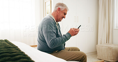 Buy stock photo Bedroom, texting and senior man with phone, online or communication with contact on social media app. Reading, message and happy person with mobile on bed, retirement and networking on web in home