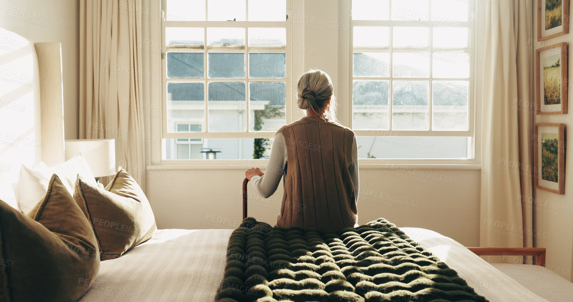 Buy stock photo Thinking, window and back of senior woman in bedroom for nostalgia, remember or reflection. Walking stick, ideas and elderly person in retirement on bed for relax, memory or planning for day in house