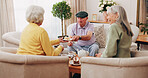 Friends, tea party and old people with cupcakes in home for bonding, retirement or snack together. Drinks, relax and social reunion with senior group in living room for visit, chat or gossip in house