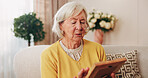 Sad, old woman and memory at house with picture frame, remembrance and nostalgia for loneliness. Grief, sentimental and senior person in lounge with photo album, reminiscing moment and mourning loss