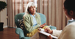 Therapy, talking and senior woman in office for grief counseling, healing and help for mental health. Retirement, psychologist and elderly person in session for support, notes and explain trauma