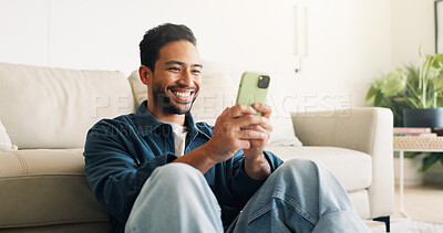 Buy stock photo Text, connection and man in house with phone, online chat and post reaction on social media app. Reading, happy or person on floor with tech, message notification or communication on digital platform