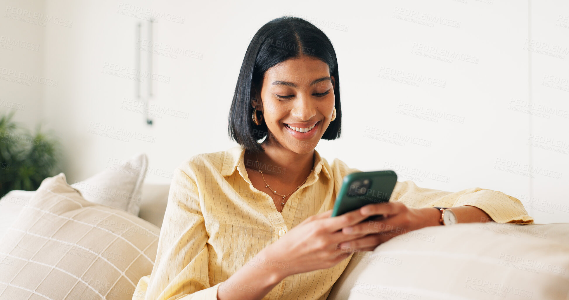 Buy stock photo Messaging, connection and woman in house with phone, online chat or post update on social media app. Reading, space or happy person with tech, text notification or communication on digital platform.