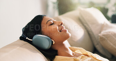 Buy stock photo Headphones, happy and woman on sofa in home listening to music, playlist and album on app. Relax, audio tech and person streaming online radio, track or song for break in living room at house.