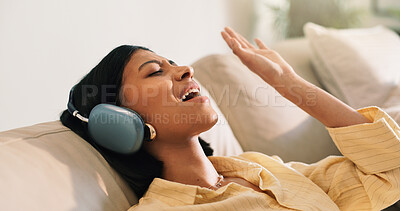 Buy stock photo Headphones, singing and woman on sofa in home for listening to music, playlist and online album. Relax, audio tech and happy person streaming radio, track or song for break in living room at house
