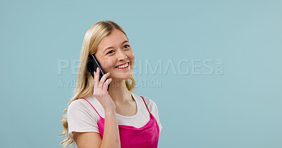 Buy stock photo Smile, woman and phone call in studio with communication, news or advice on blue background. Mobile, mockup space and happy person listening to contact for gossip, connection and feedback with story