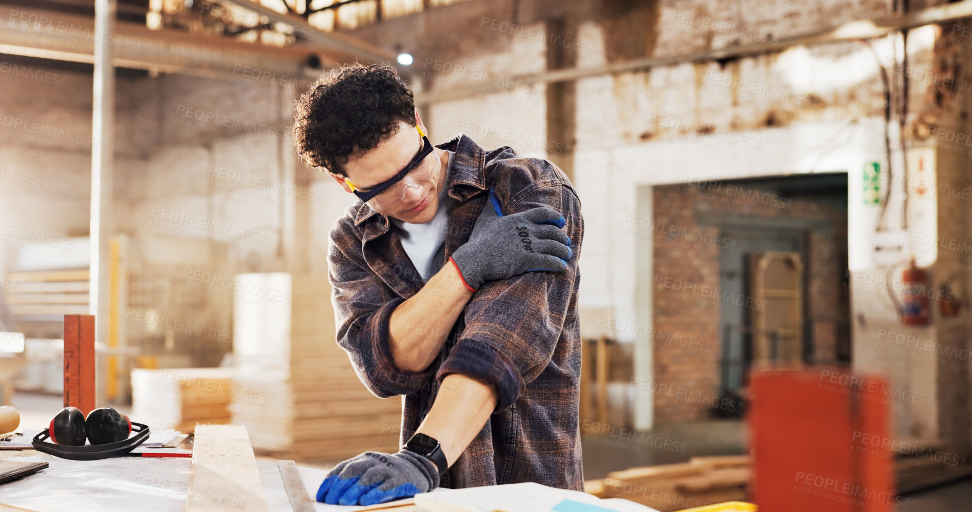Buy stock photo Carpenter, injured and man in workshop with wood for manufacturing, shoulder pain and production. Person, hurt and warehouse with strain for custom or handmade woodworking, dislocation and timber