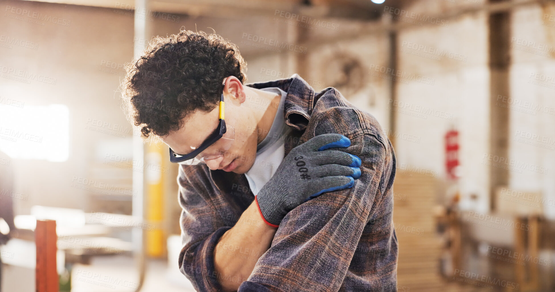 Buy stock photo Carpentry, injury and man in workshop with wood for manufacturing, shoulder pain and production. Person, hurt and warehouse with strain for custom or handmade woodworking, dislocation and timber